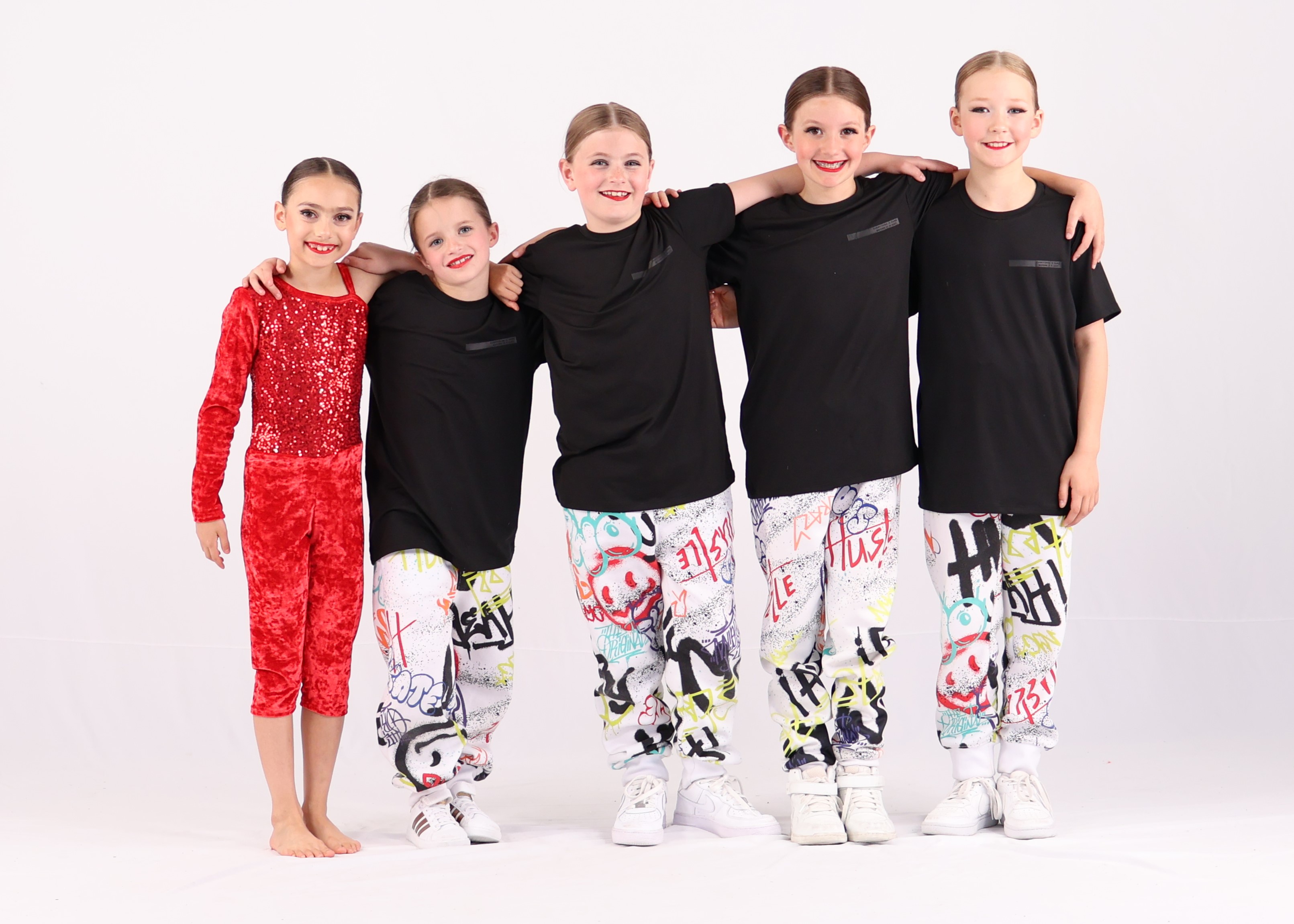 Yearend dance recital at Revolution Dance Calgary – dancers performing on stage with costumes and smiles