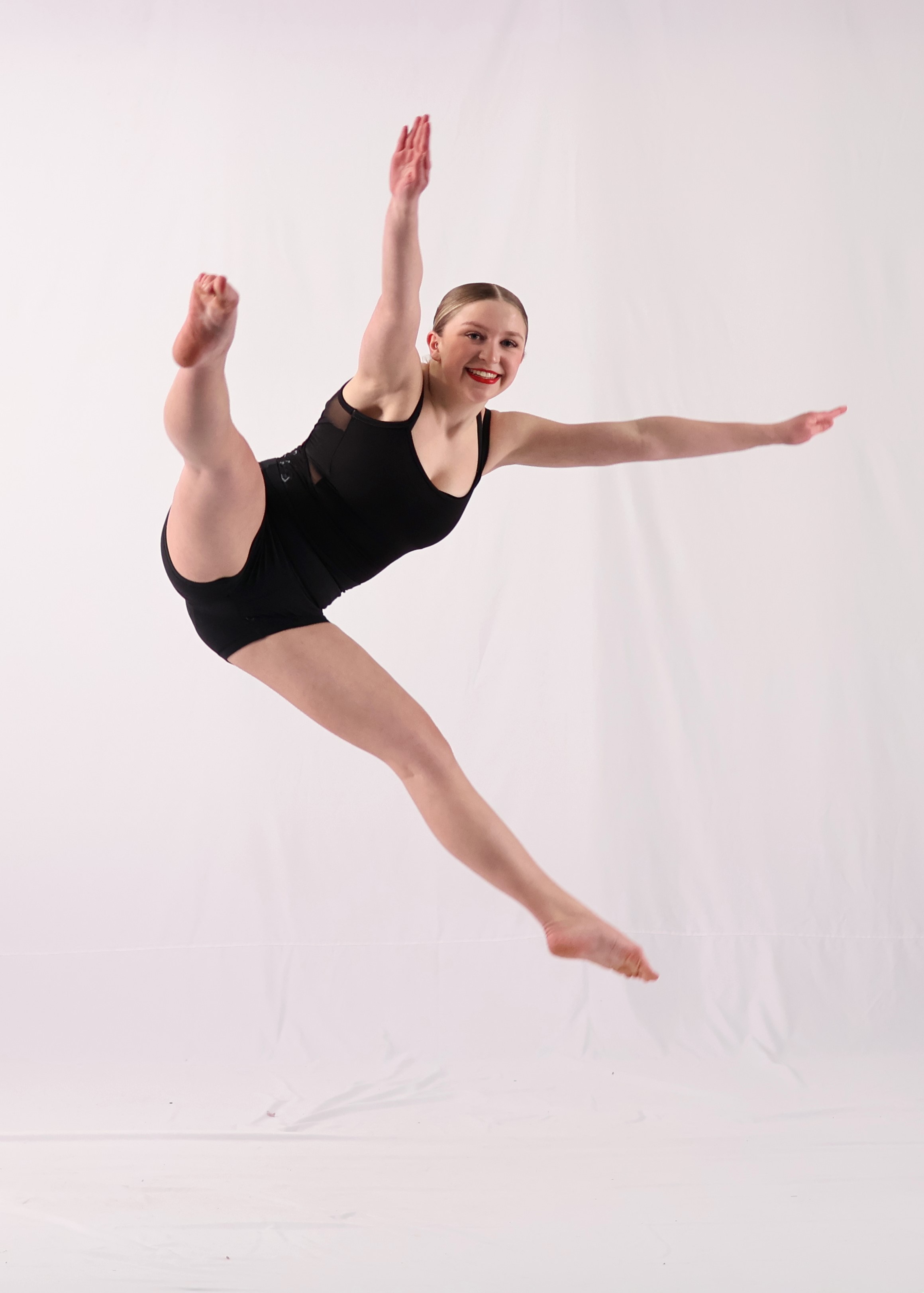 Excited dancers showcasing ballet, jazz, and hip hop routines during the Revolution Dance year-end recital in Calgary