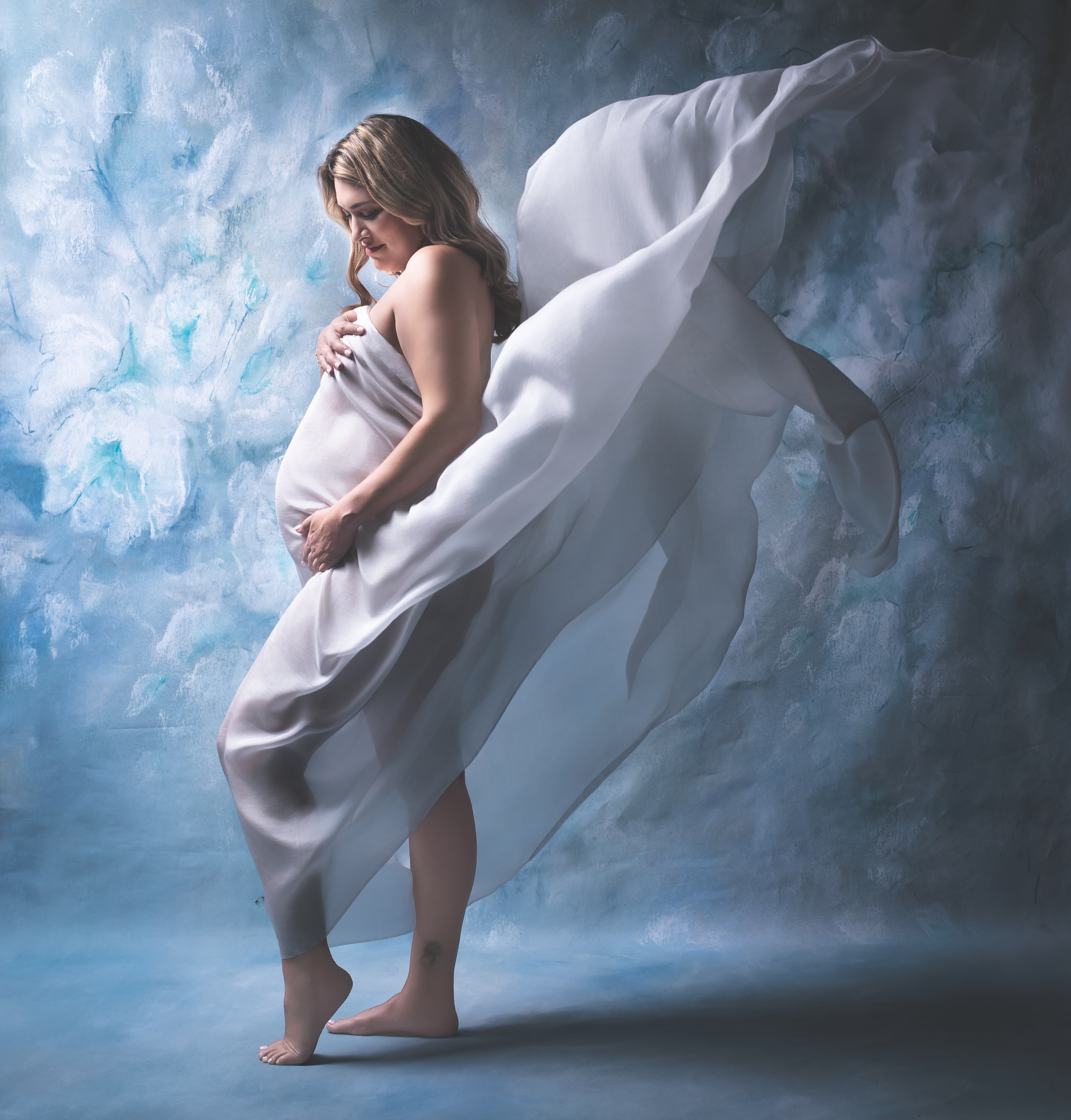 Atlanta maternity photographer captures elegant milk bath photoshoot with pregnant mother surrounded by soft florals