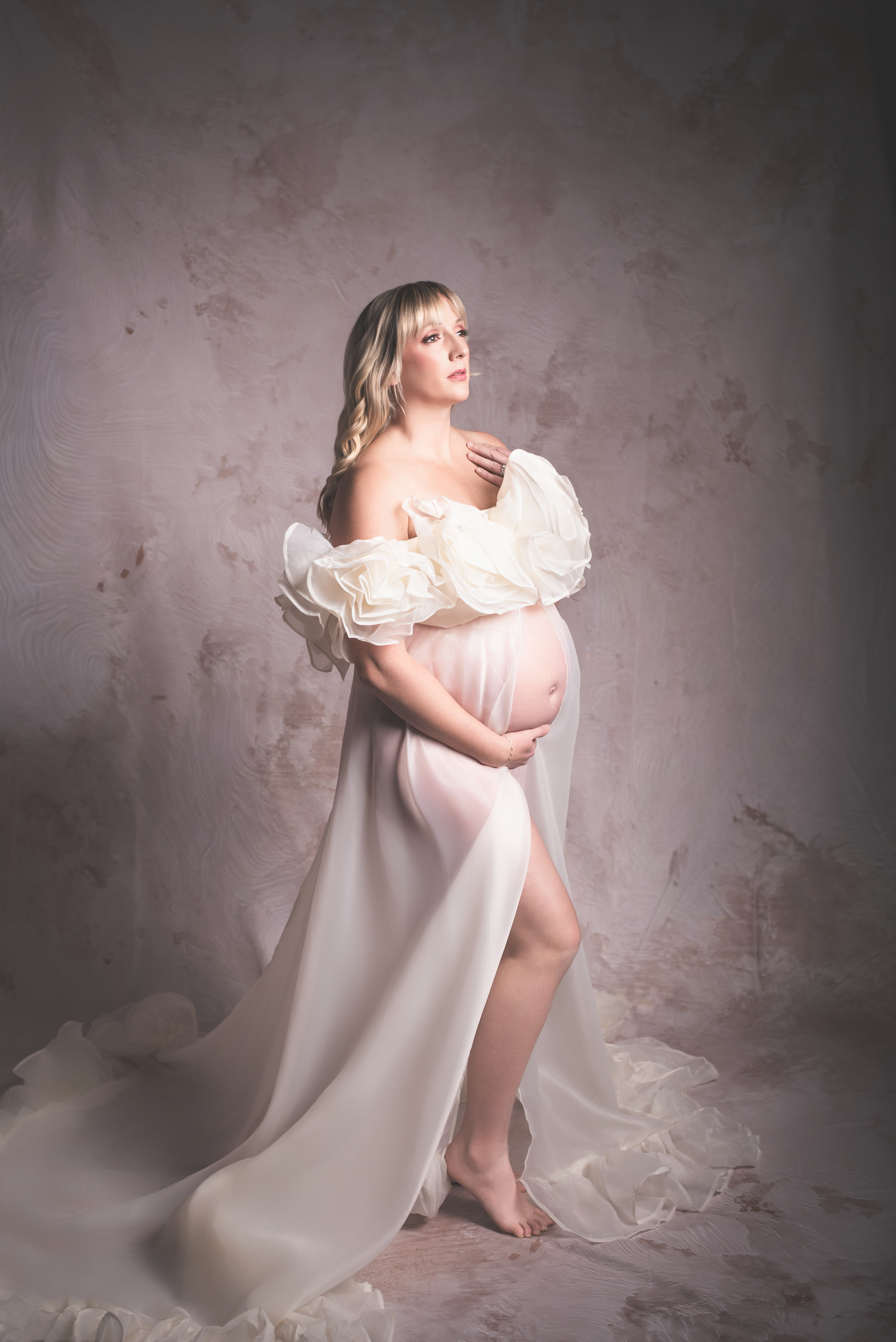 Artistic Maternity photo of woman wearing a gown for maternity photos  in Atlanta