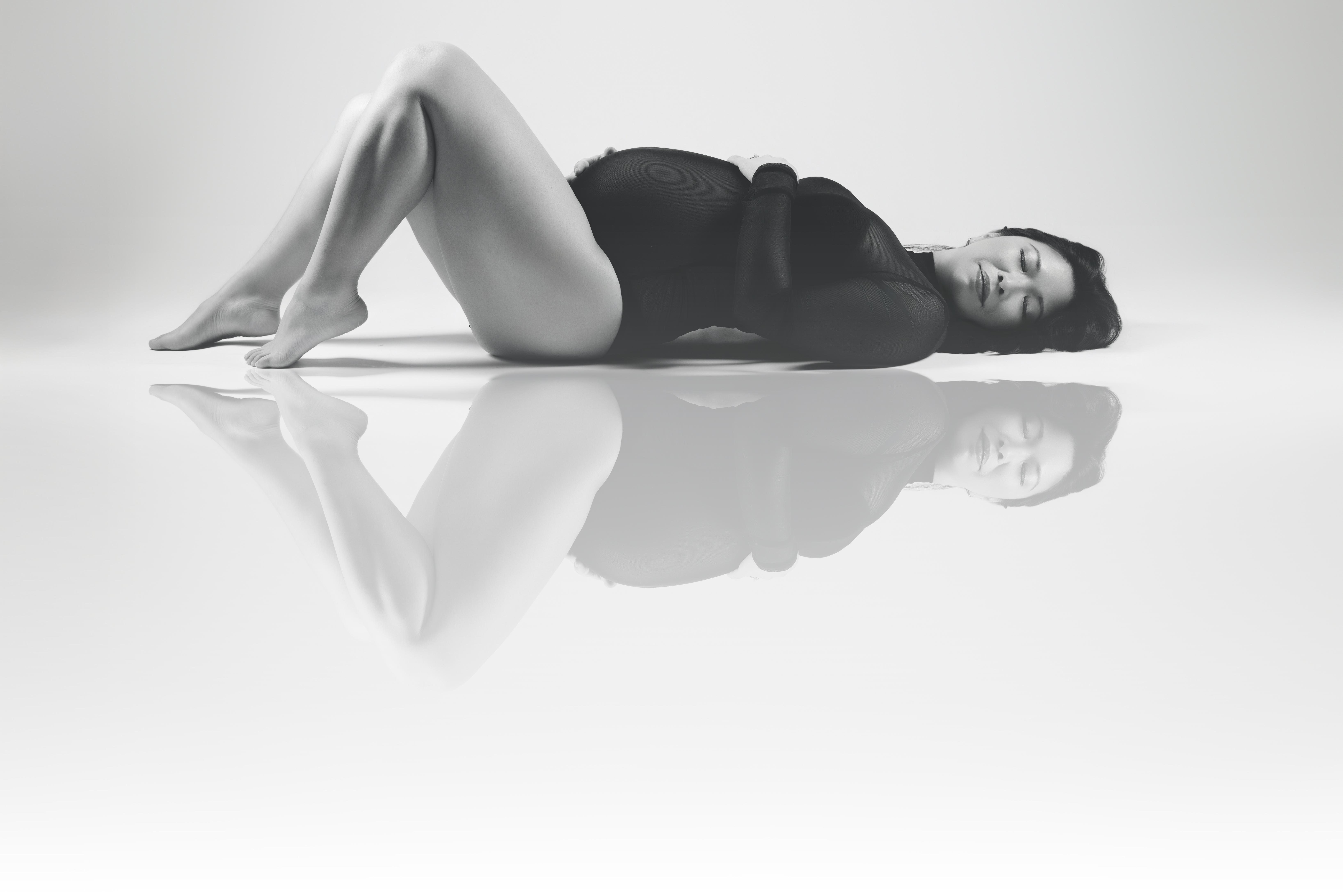 woman high fashion maternity laying down with bodysuit atlanta ga