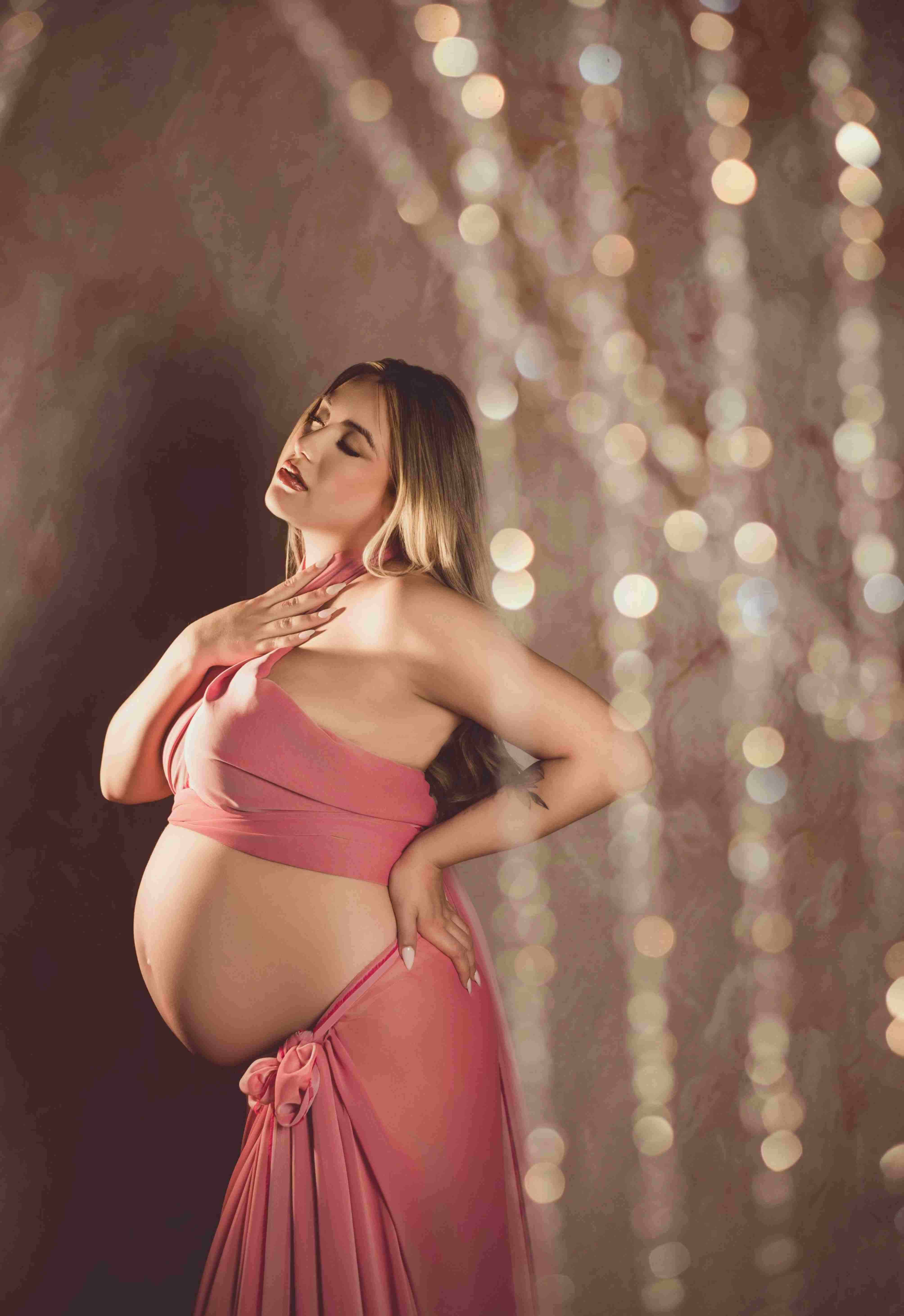 Atlanta maternity photographer captures elegant milk bath photoshoot with pregnant mother surrounded by soft florals