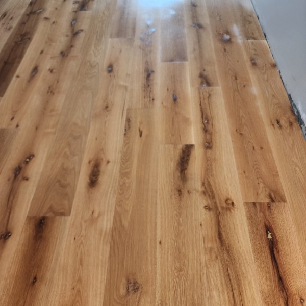 New boards woven into an existing hardwood floor during a repair