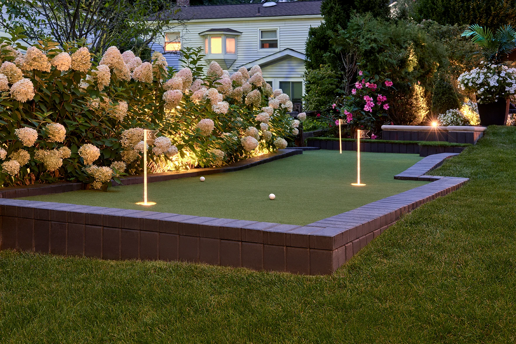Putting green in a raised hardscape by Bollman Landscape Putting green in a raised hardscape by Bollman Landscape