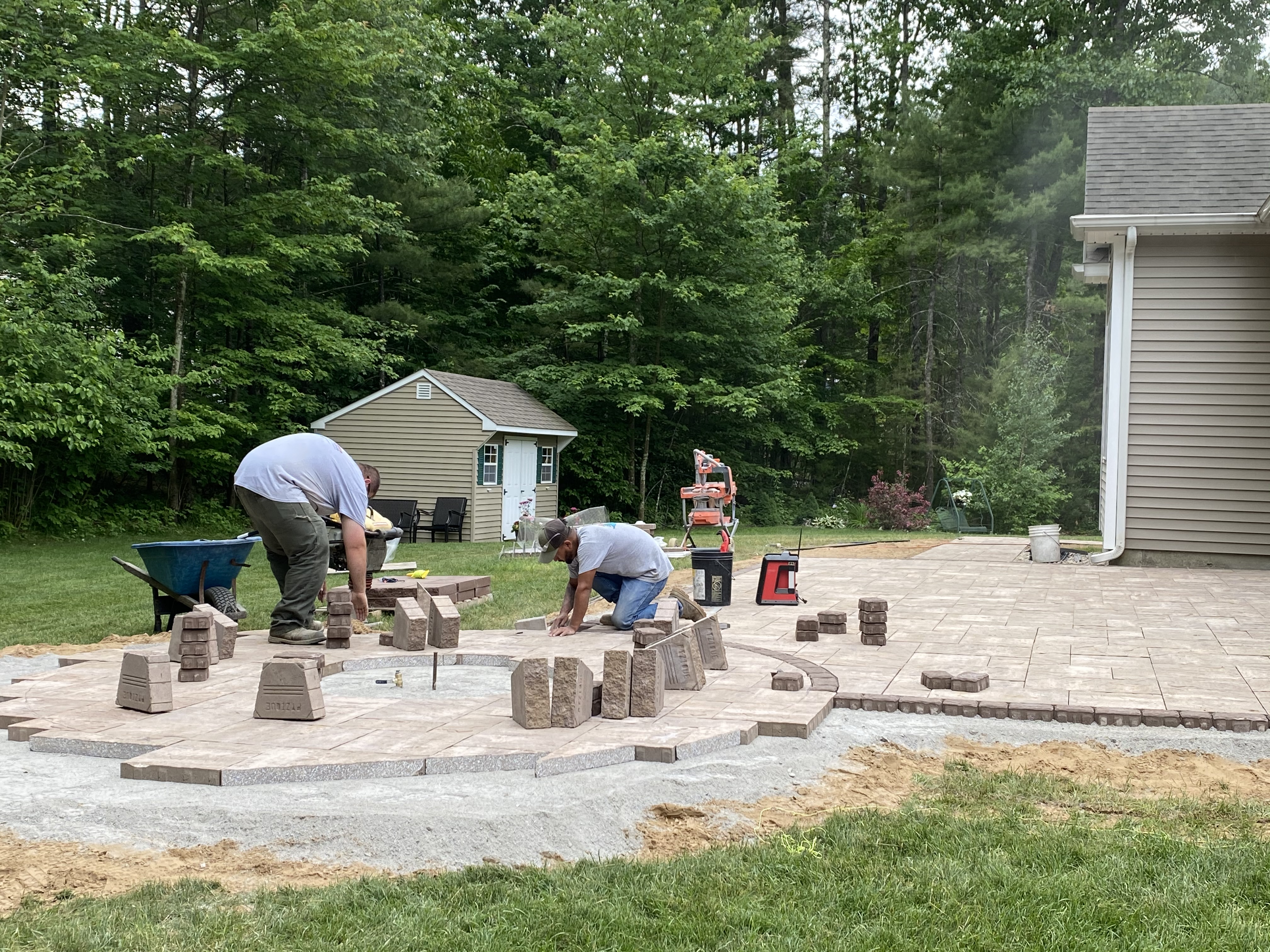 Workers from Bollman Landscape laying a beautiful, structurally-sound patio