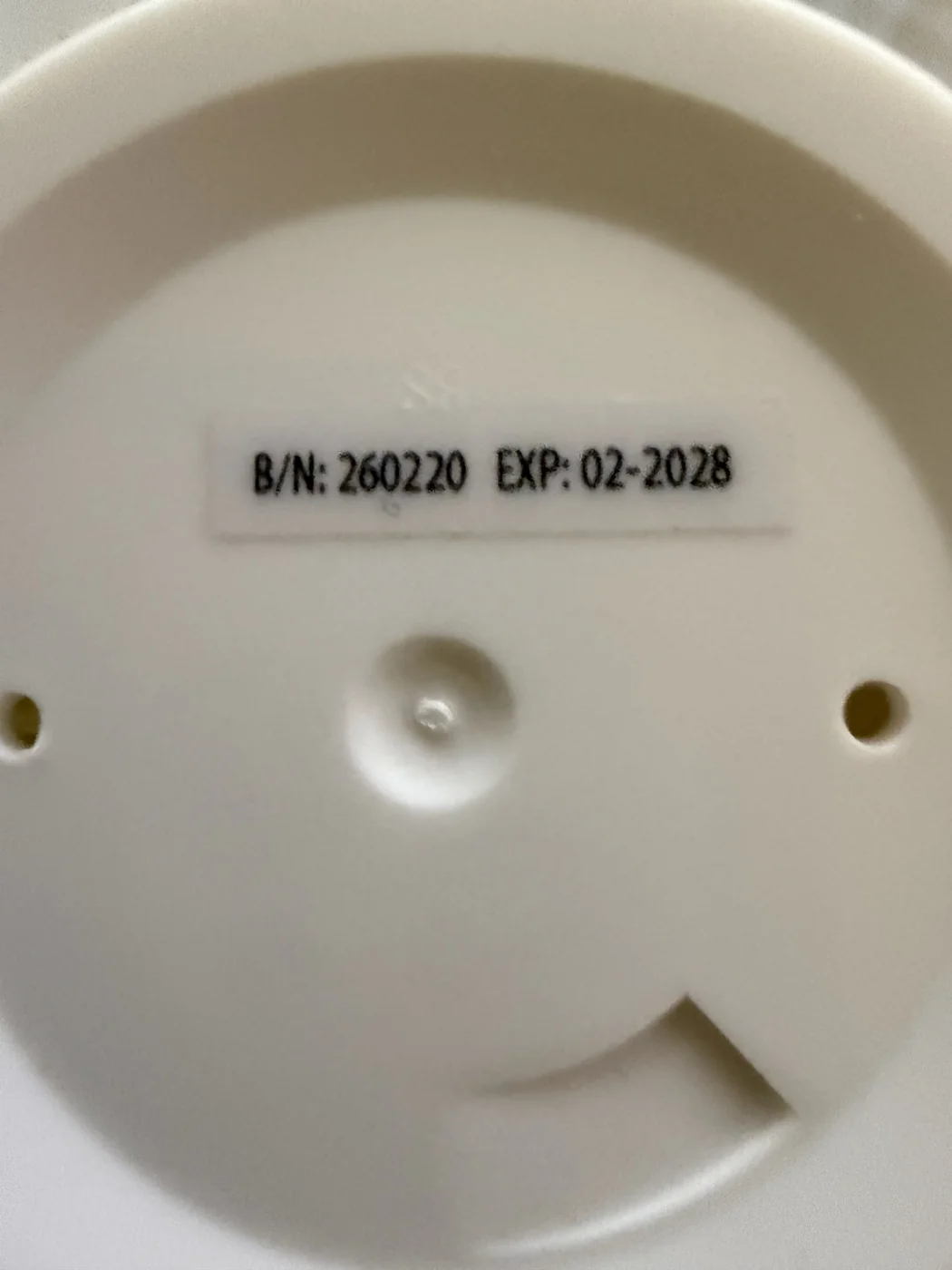 Batch number B/N 260220 and expiry 02-2028 printed on the bottom of a LactiGo bottle