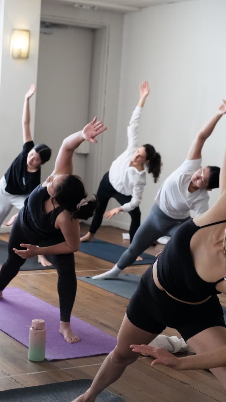 A yoga class in a side angle stretch at This Is Yoga Rozelle