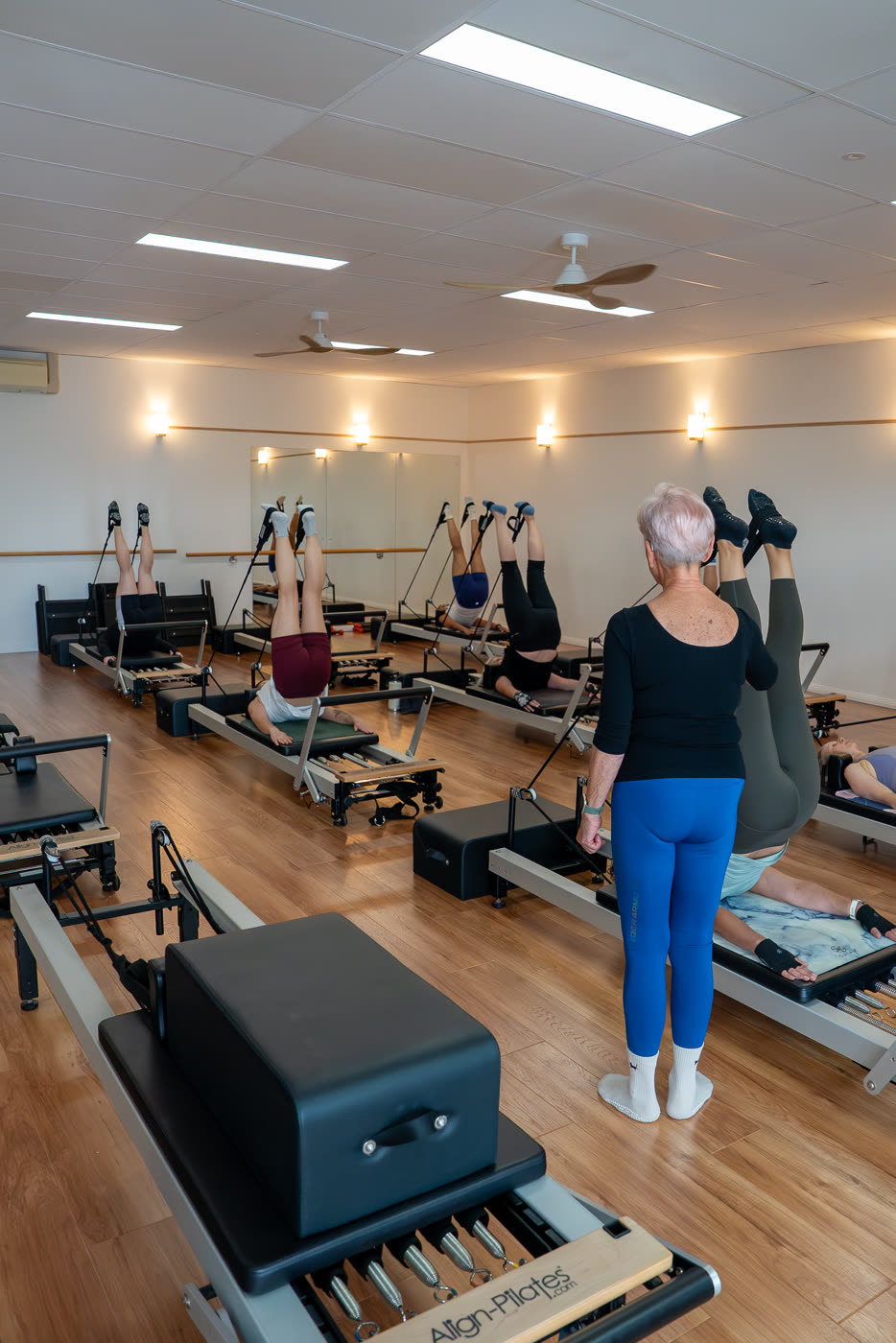 An instructor leading a reformer class at This Is Pilates Bathurst