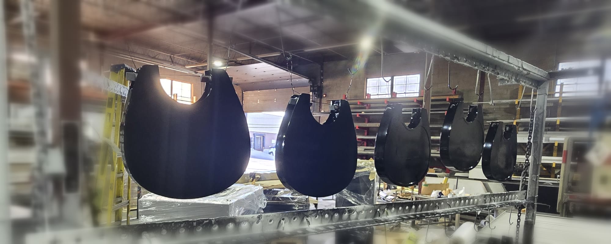 Black Klimbo K01 step shells hanging after powder coating