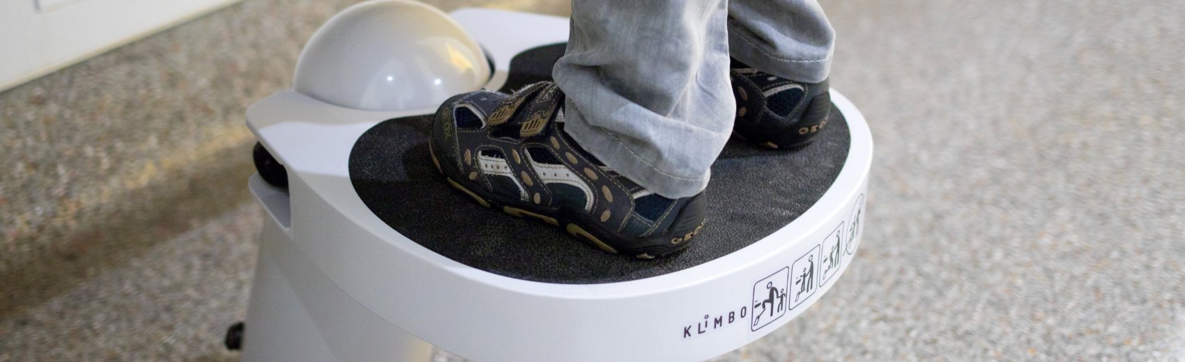 Close up of a child's shoes on the anti slip tread of a Klimbo step