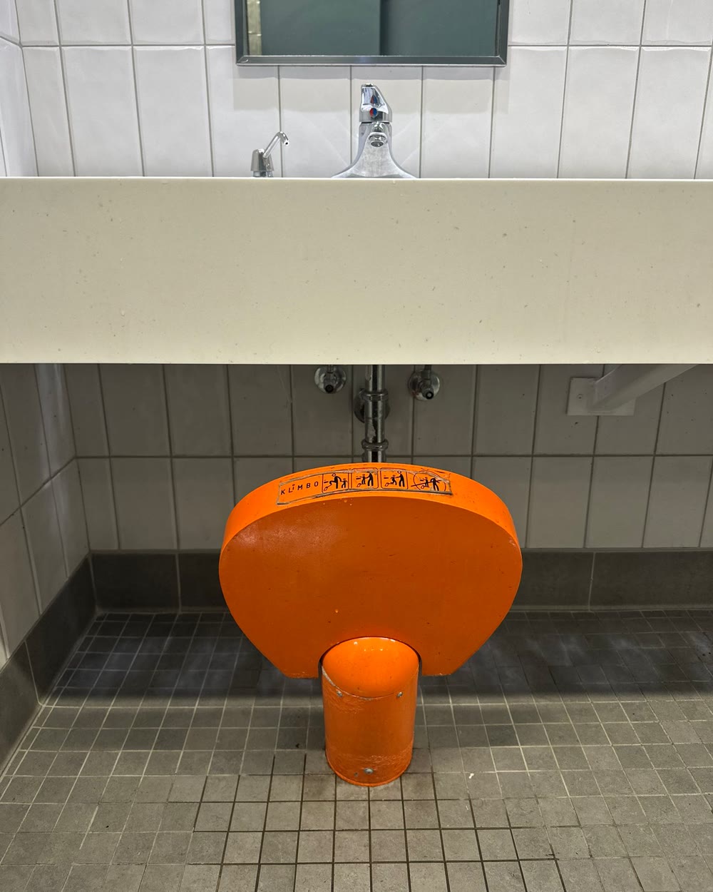 Orange Klimbo K01 installed under a public restroom sink