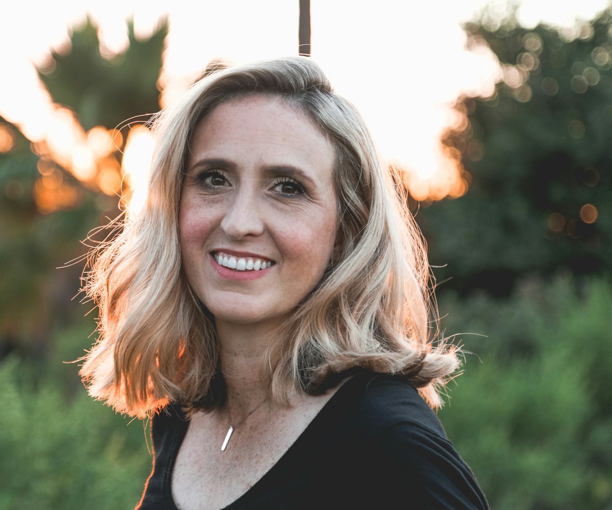 Confident woman radiating health and vitality in golden light