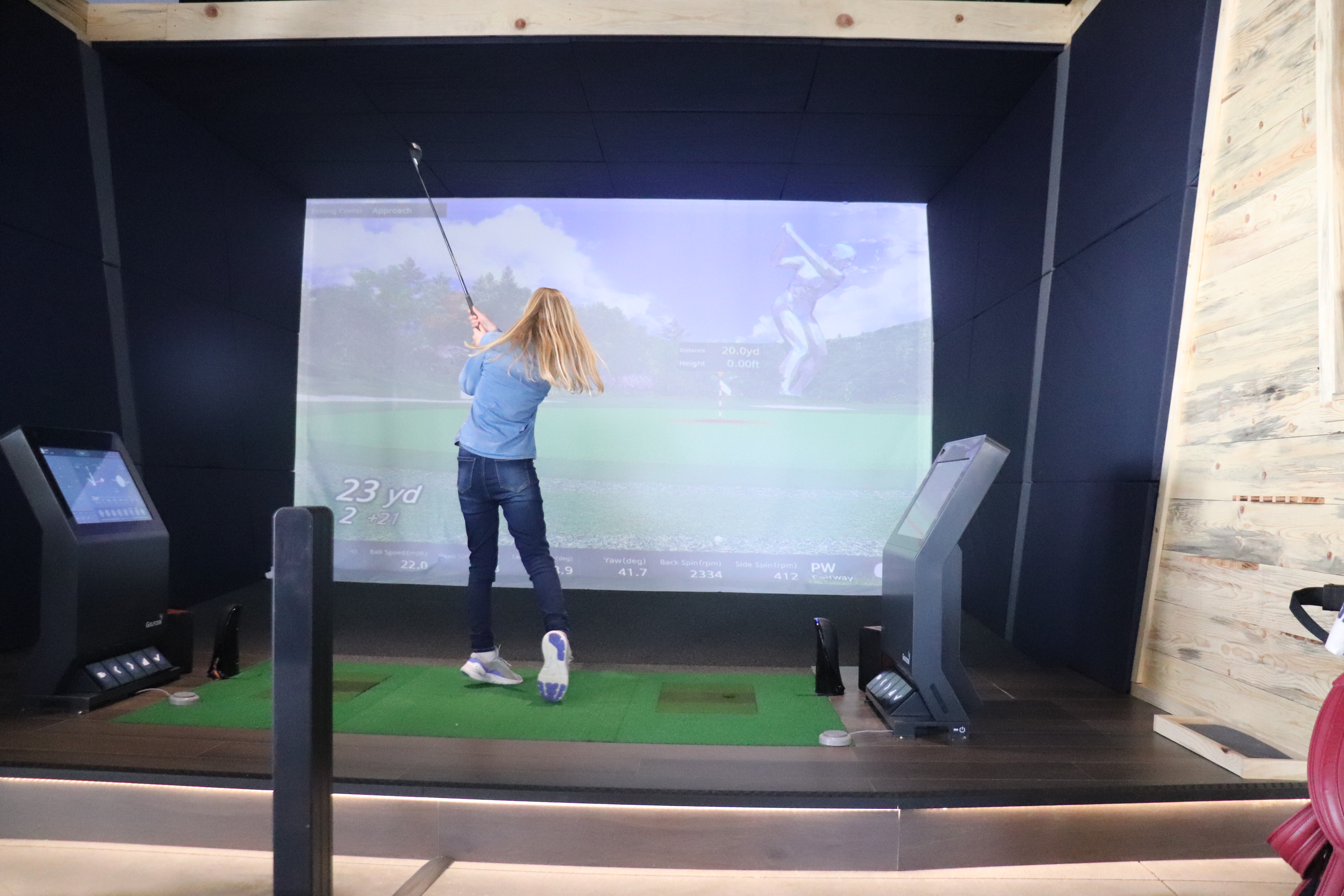 Girl swinging at Golfzon simulator - Caddie Kids Golf Camp Lone Tree Colorado