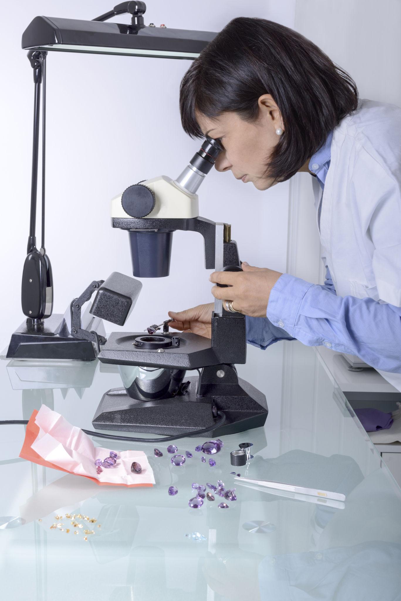 gemmologist looking in a microscope