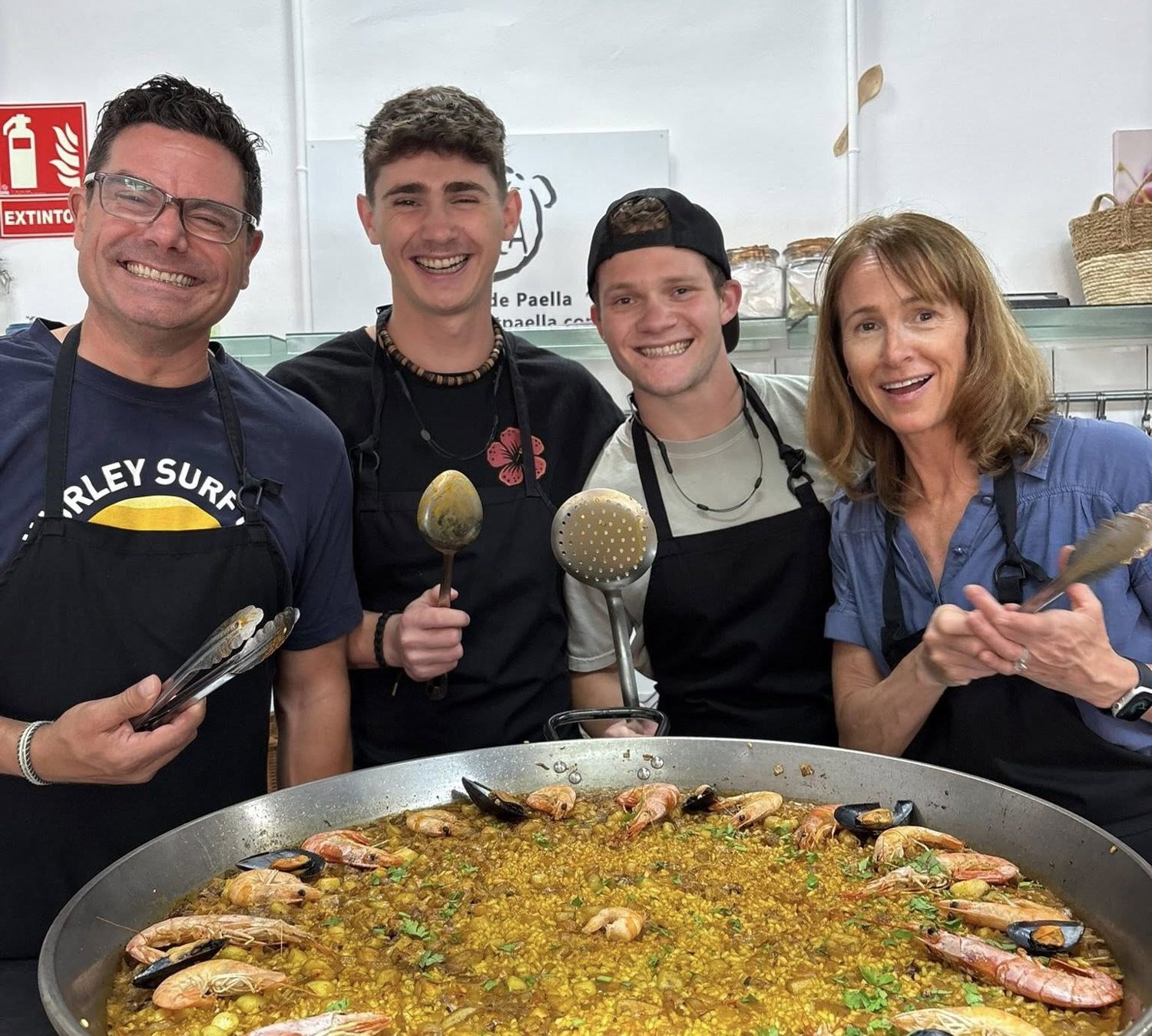 Friends gathered round a paella pan