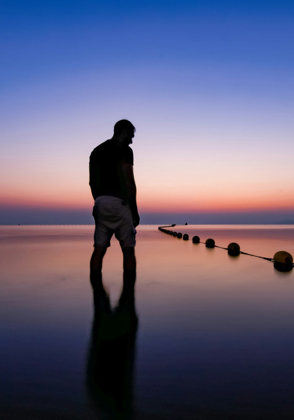 Estancia cover: a man standing in still water at dusk on the Mar Menor