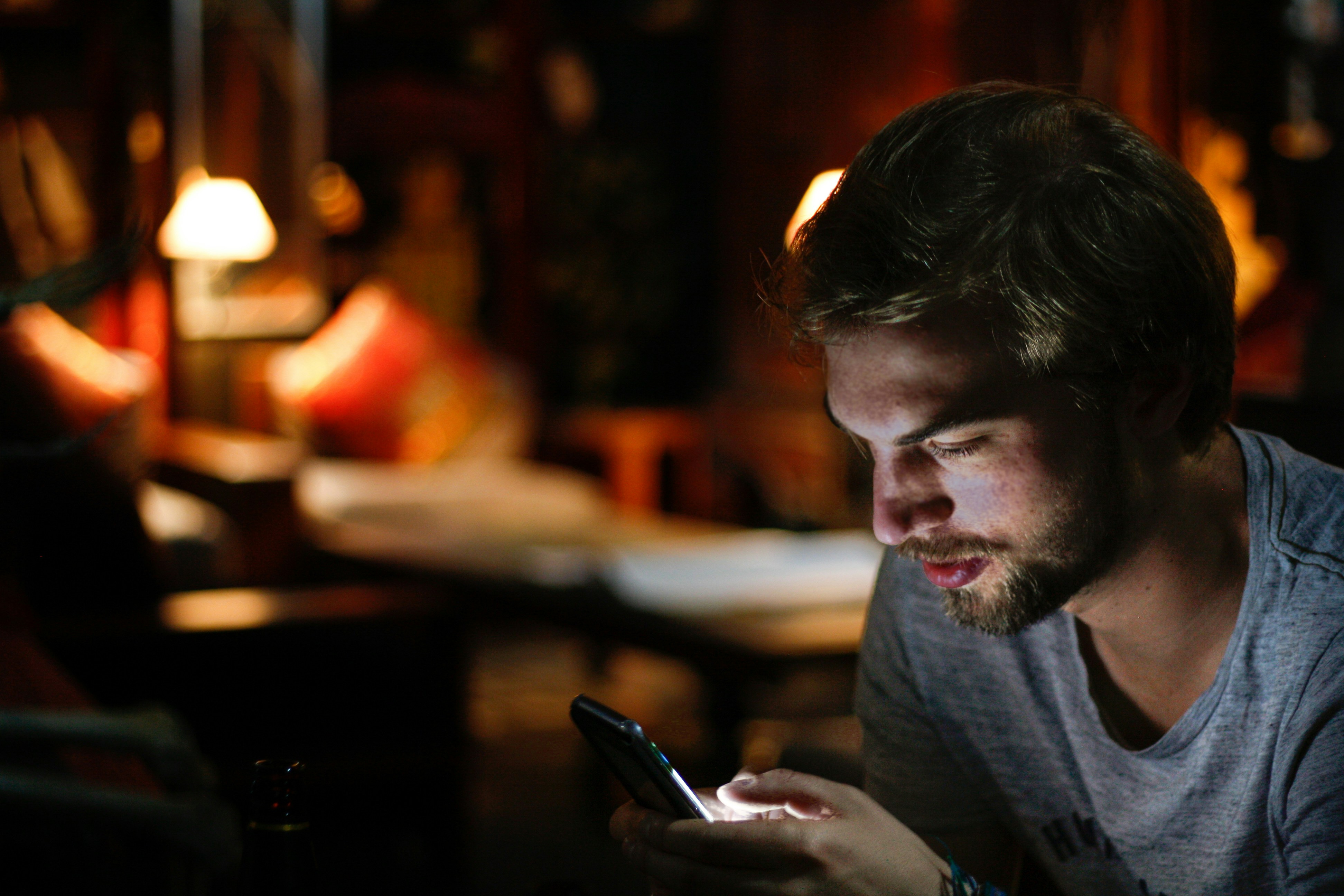 Phone lighting up at night with a text