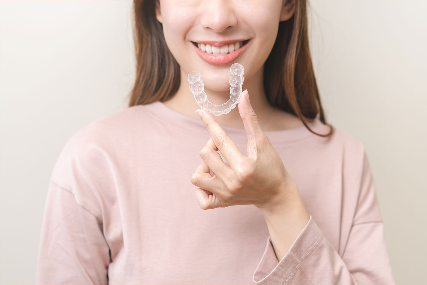 Woman holding invisalign