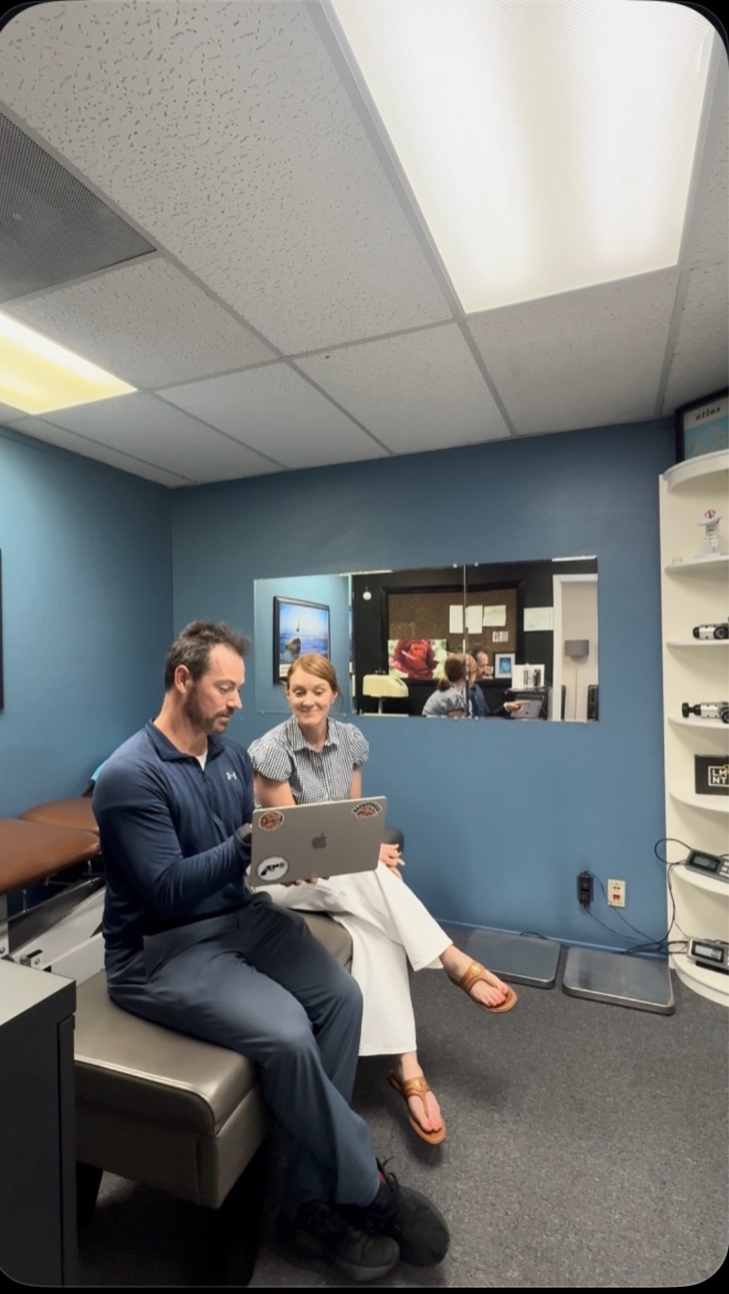 Dr. Callaway talking through findings with a patient on his laptop