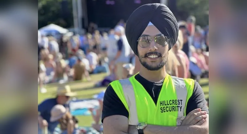 Hillcrest Security guard in a turban, sunglasses and a high-visibility HILLCREST SECURITY vest at an outdoor festival