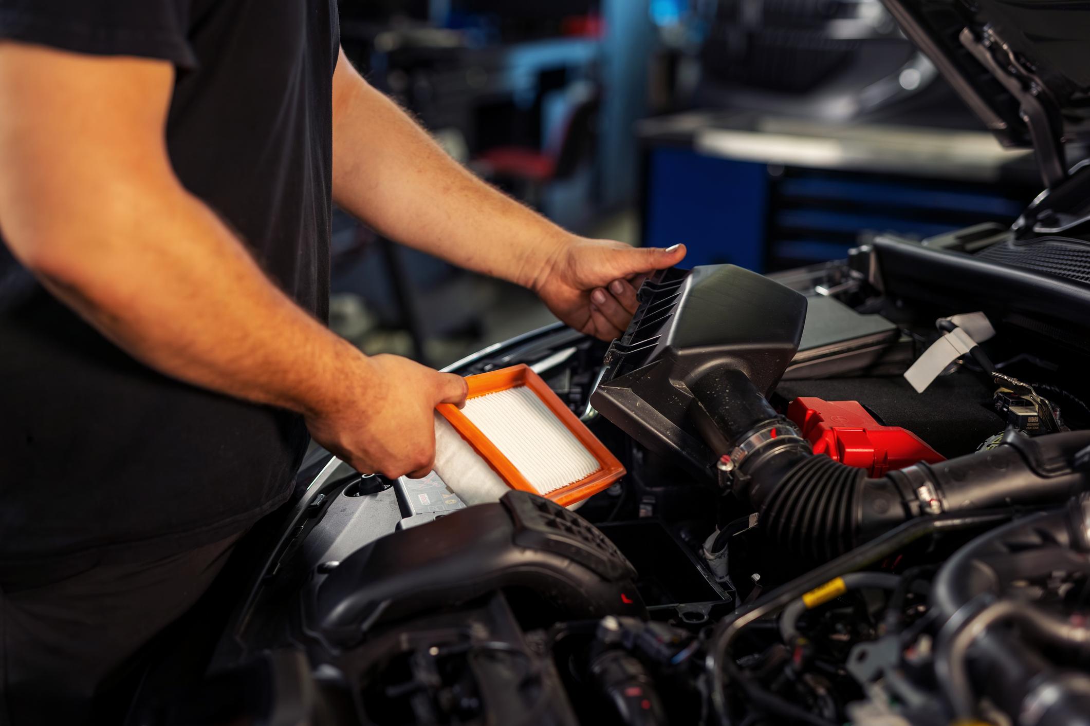 Technician performing engine tune-up and filter service at Sager & Sons Auto in Boise, ID