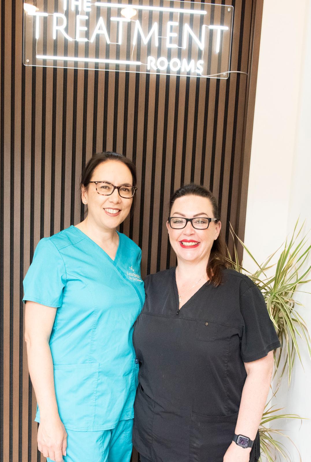 Dr Emma Castro and The Treatment Rooms team beneath the clinic sign in Braintree, Essex
