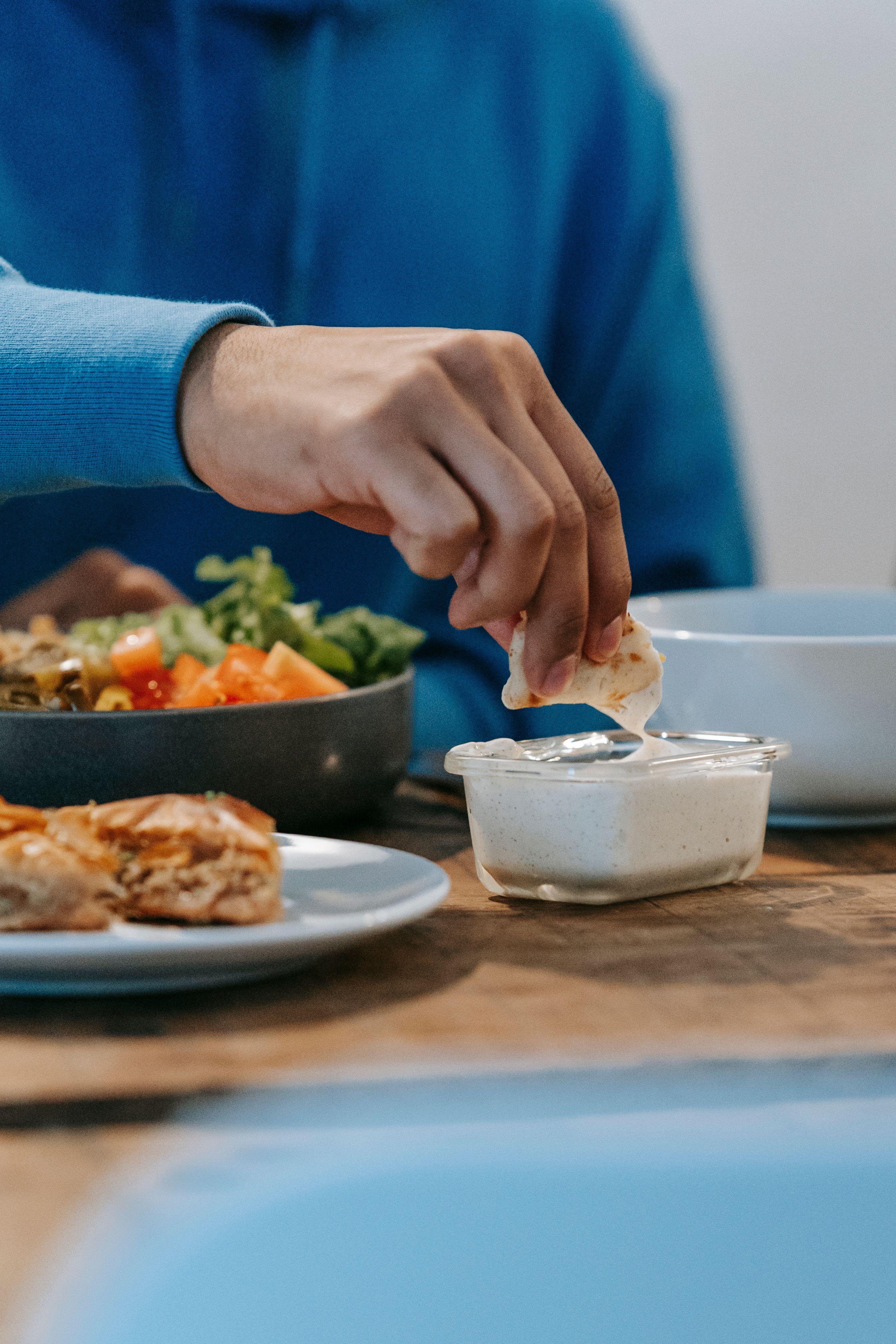 Person writing in a food journal, tracking meals as part of the OC Nutrition habit