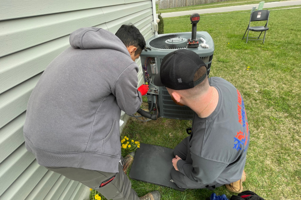 expert repairing heat pump