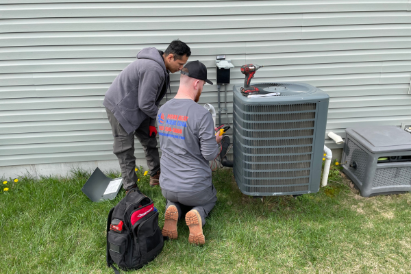 photo of man repairing ac unit