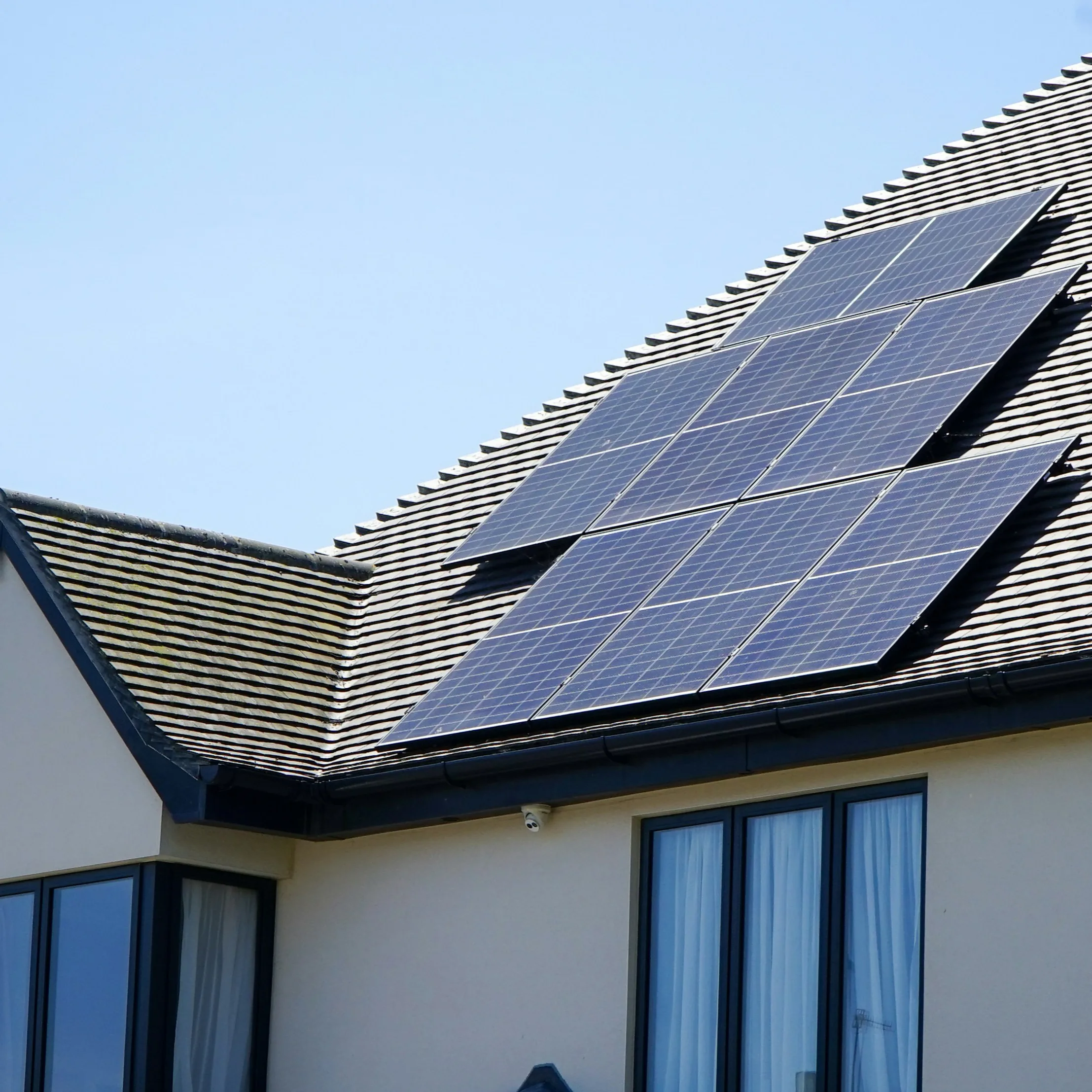 Roof-mounted solar panels on a Birmingham house, installed as a solution to high energy bills.