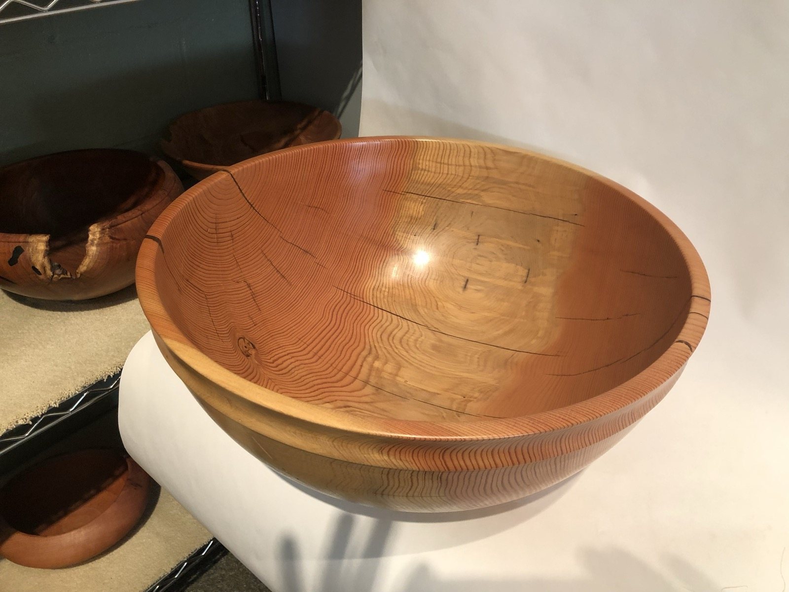 Smooth turned wooden bowl with a rounded profile
