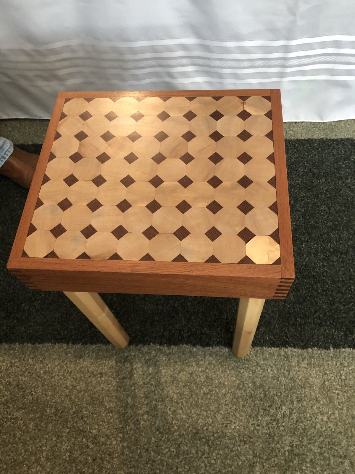 Wooden side table with contrasting geometric inlay