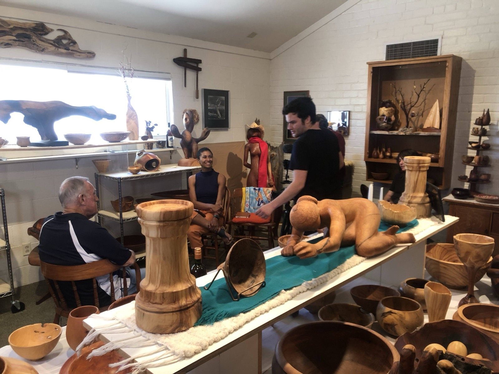 Wood sculptures and vessels arranged together in the studio