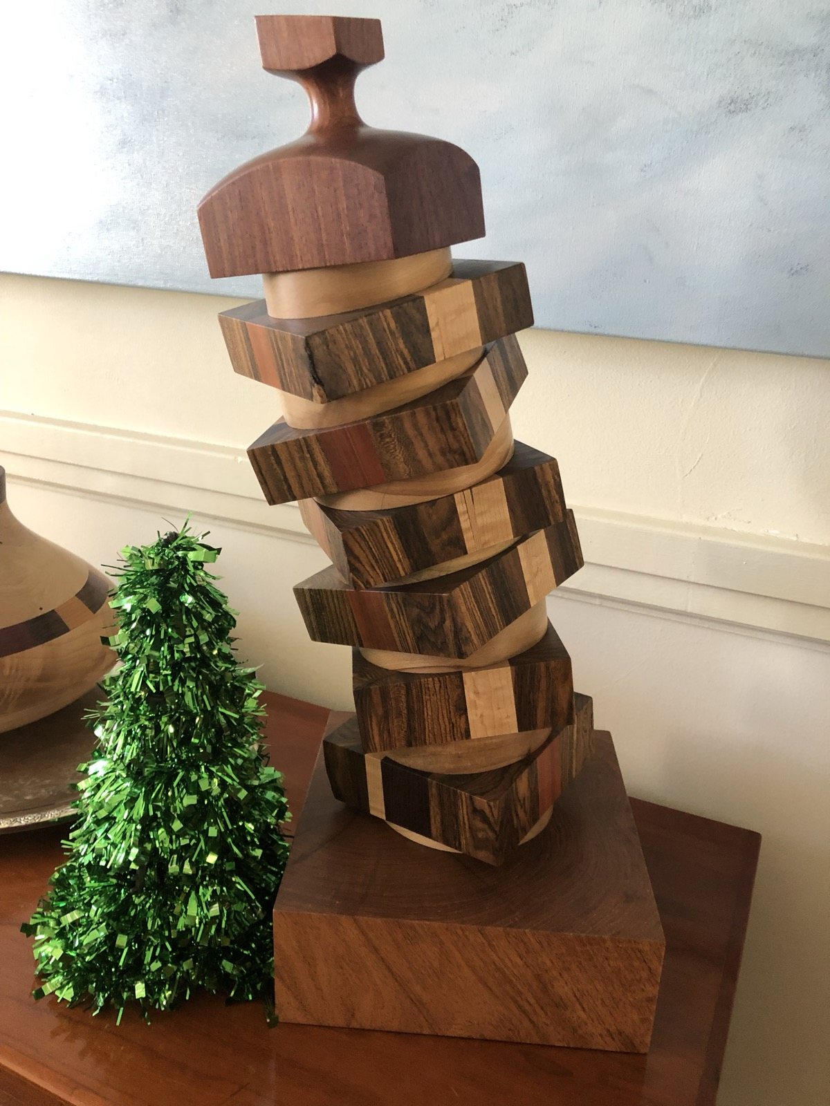 Stacked wood figure combining contrasting wood colors