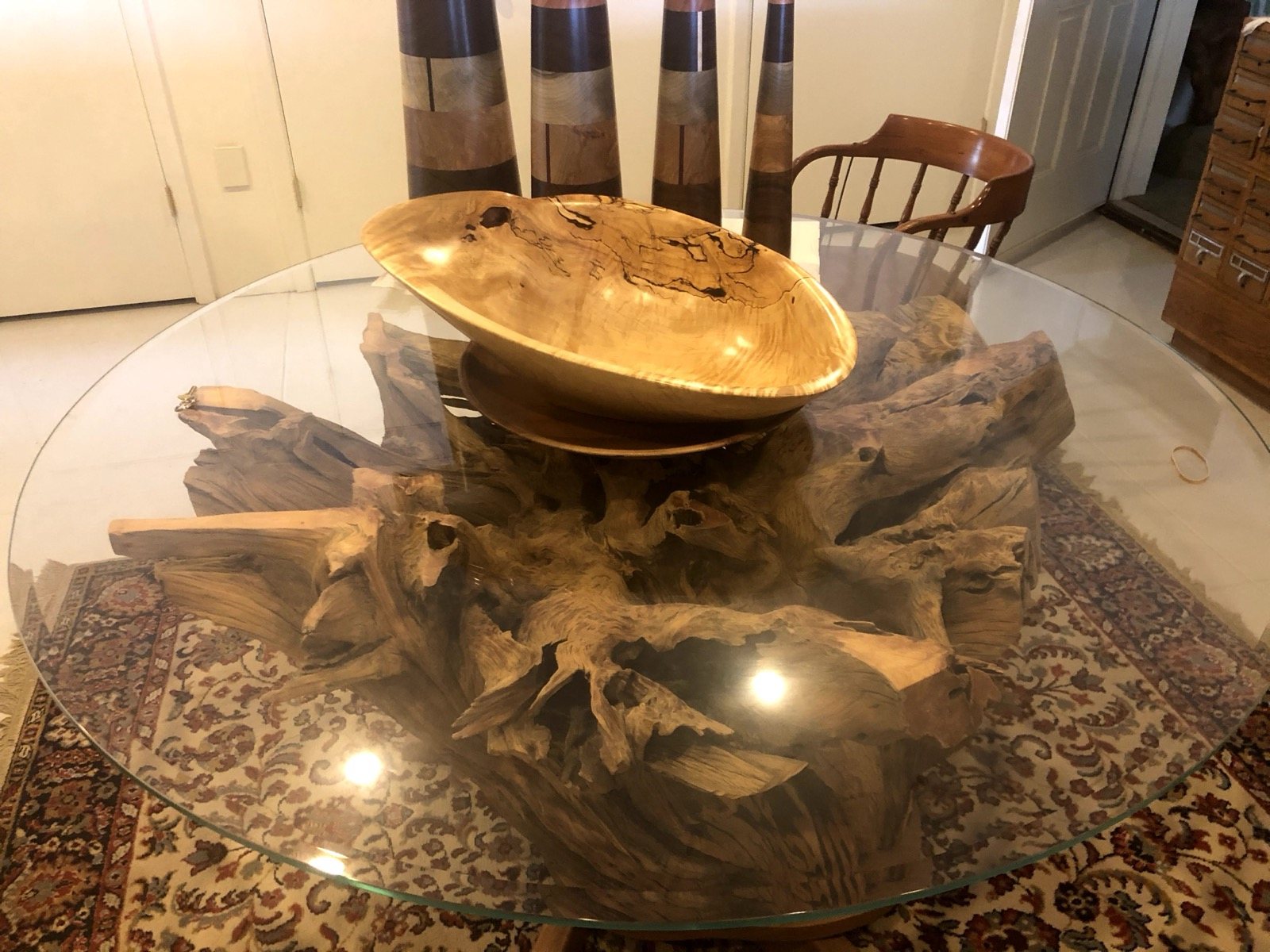 Alternate view of a glass tabletop and natural wood base