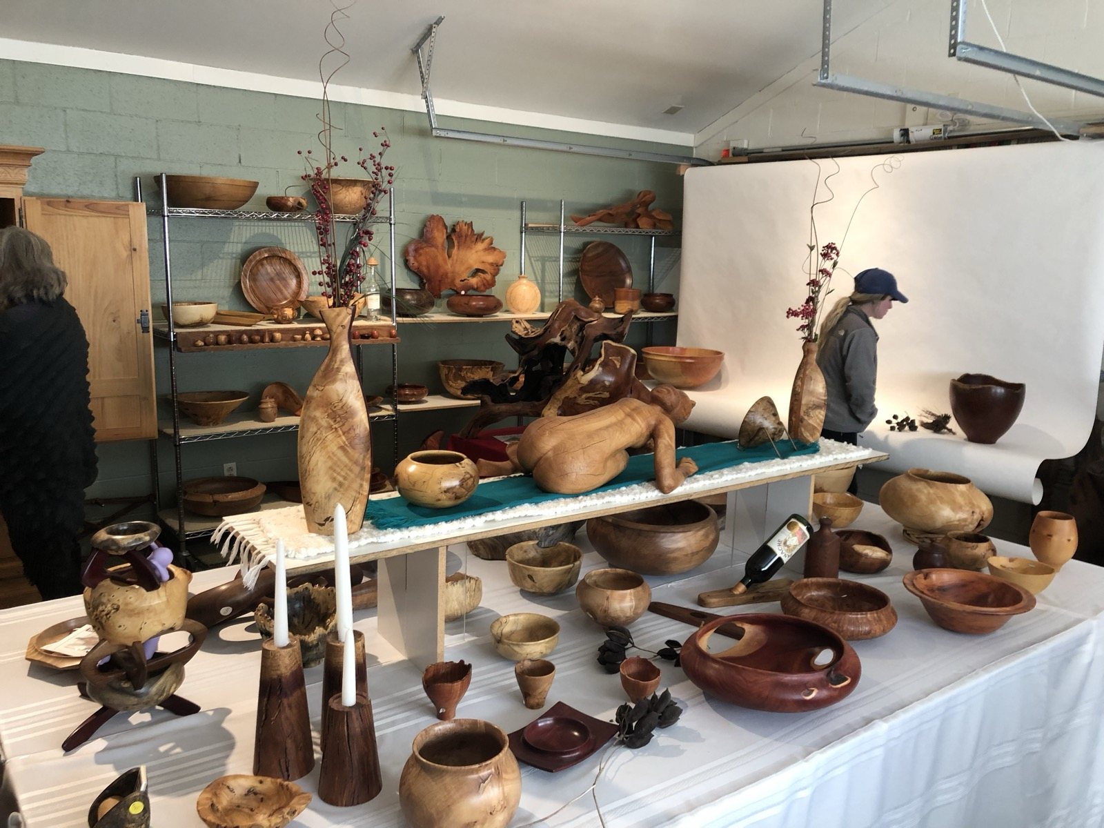 A wide view of sculptures, bowls, and vessels displayed together