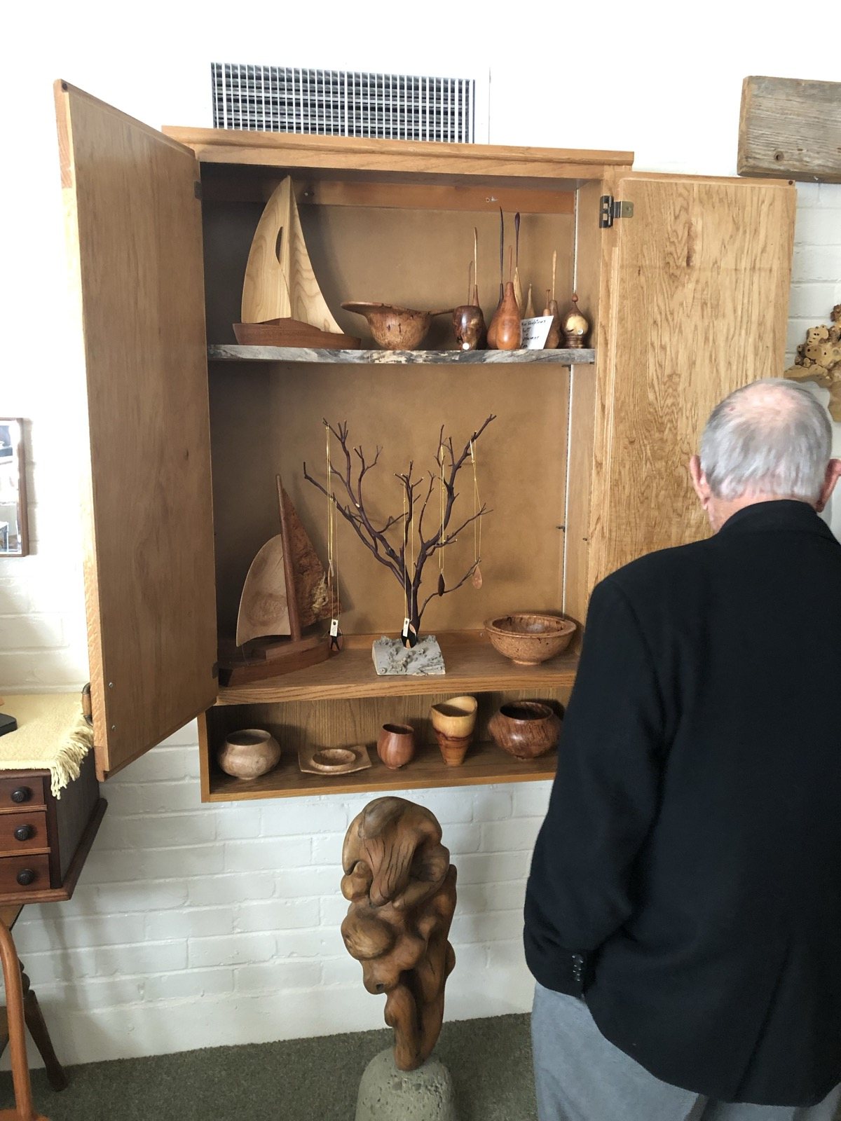 Wood artwork displayed in a studio cabinet