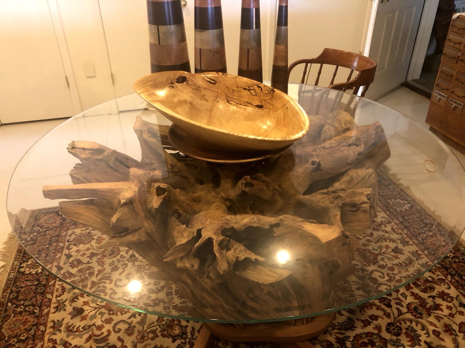 Glass tabletop displaying the natural form of a wood base