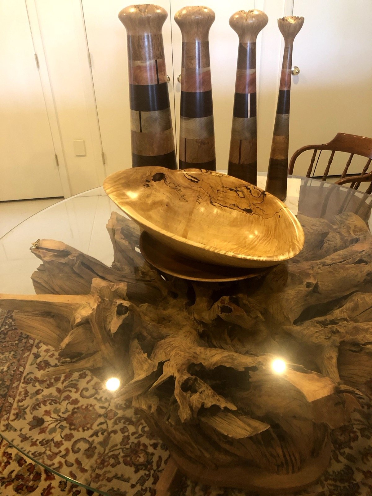Wooden bowl displayed on the glass and wood table