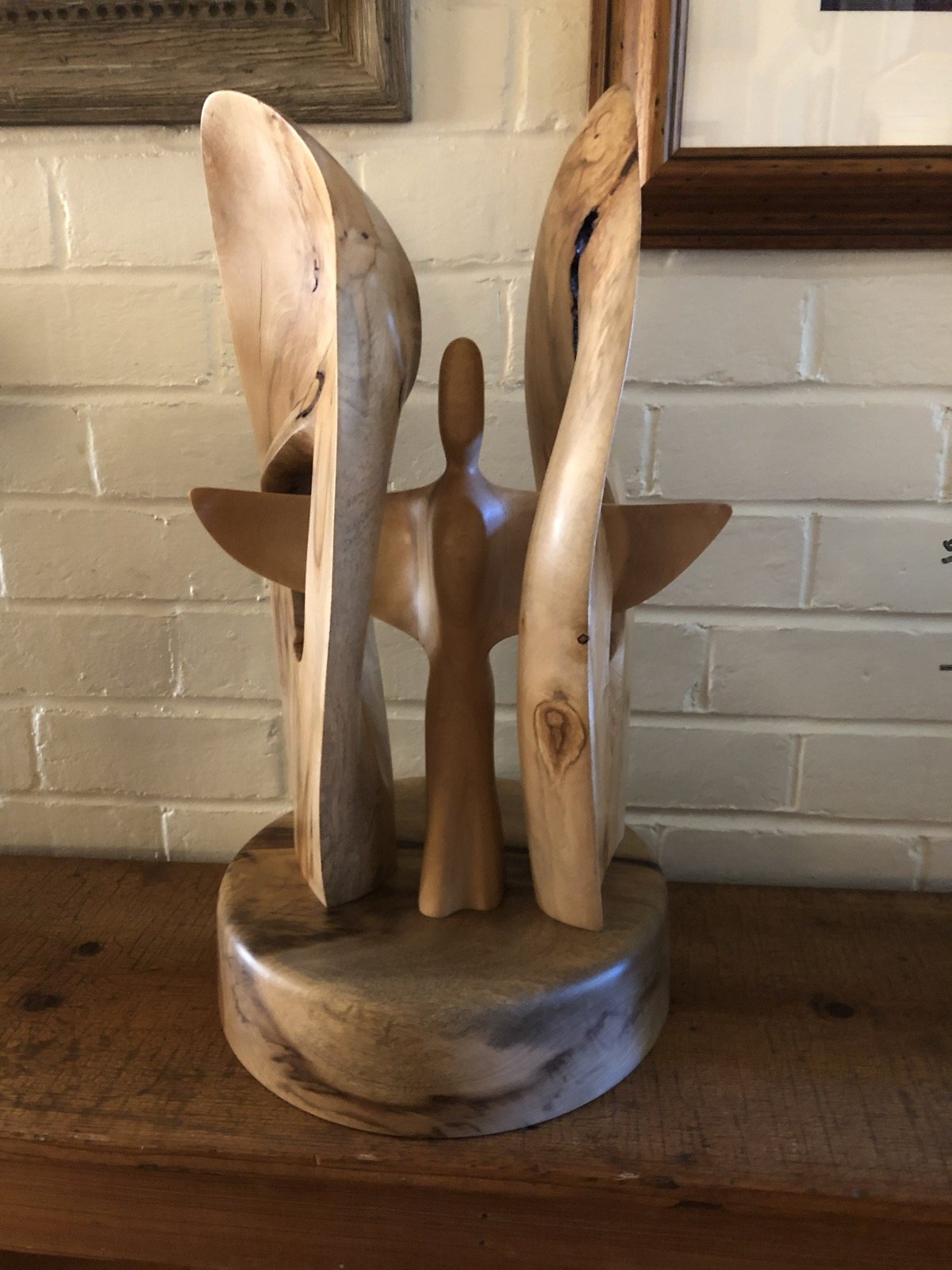 Alternate view of tall organic wooden forms on a round base
