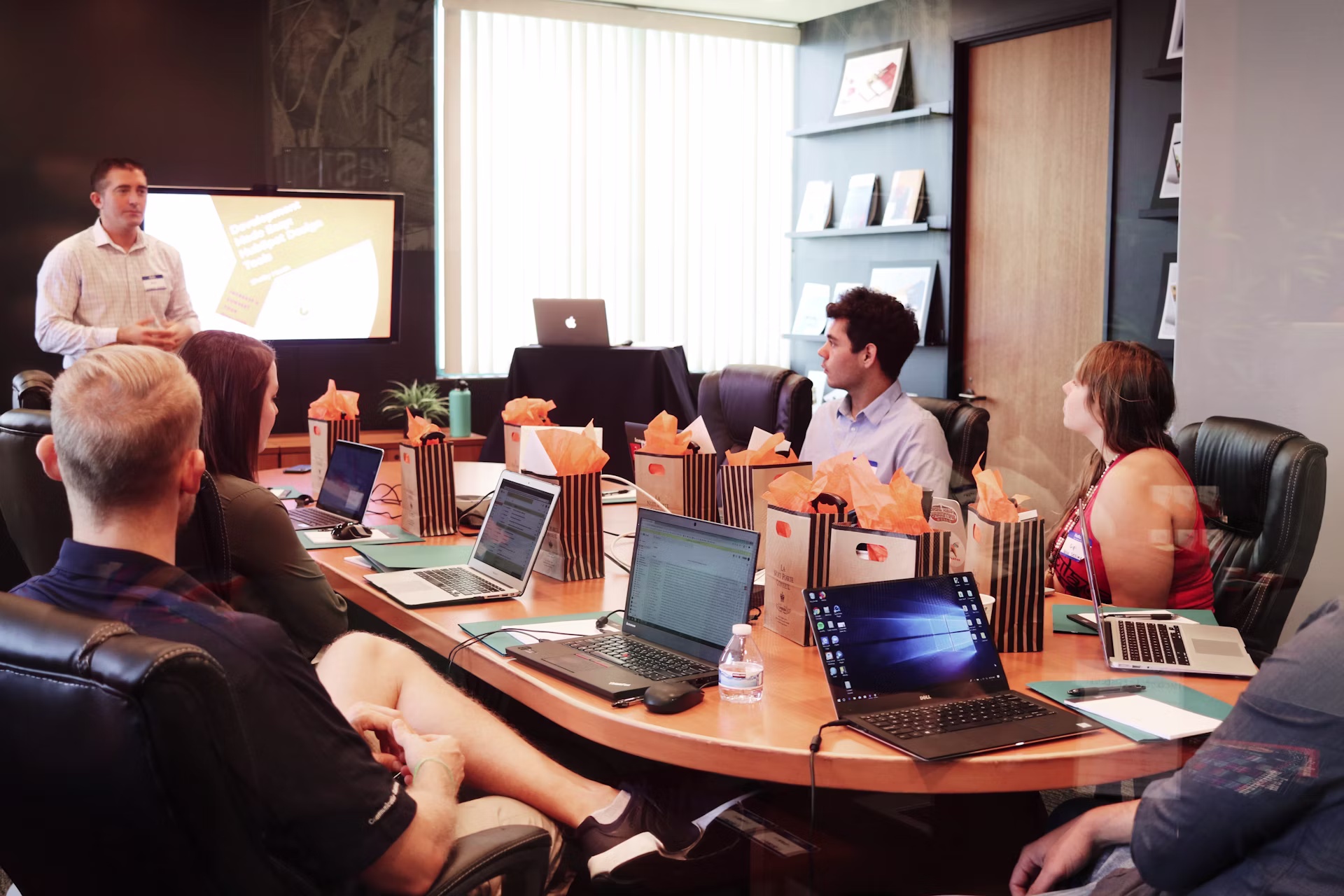 A presenter leading a room through a process in a modern office