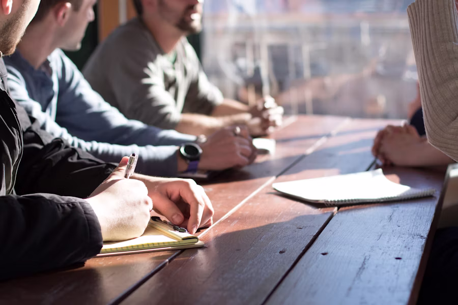 A small team reviewing a calendar full of confirmed meetings