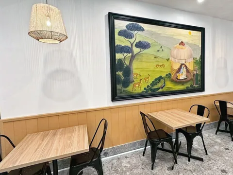 Wooden tables and rattan pendant lights in the renovated Naan Sense dining room