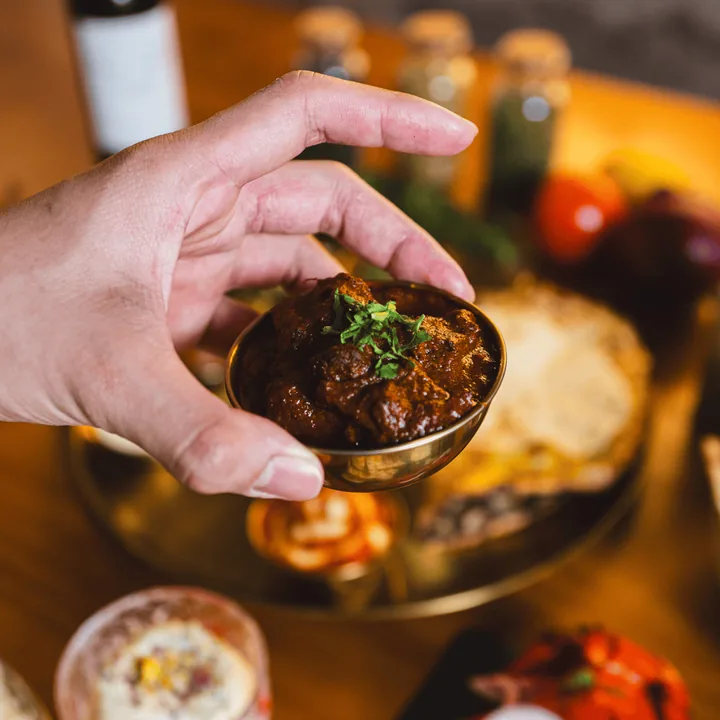 Copper bowl of lamb curry