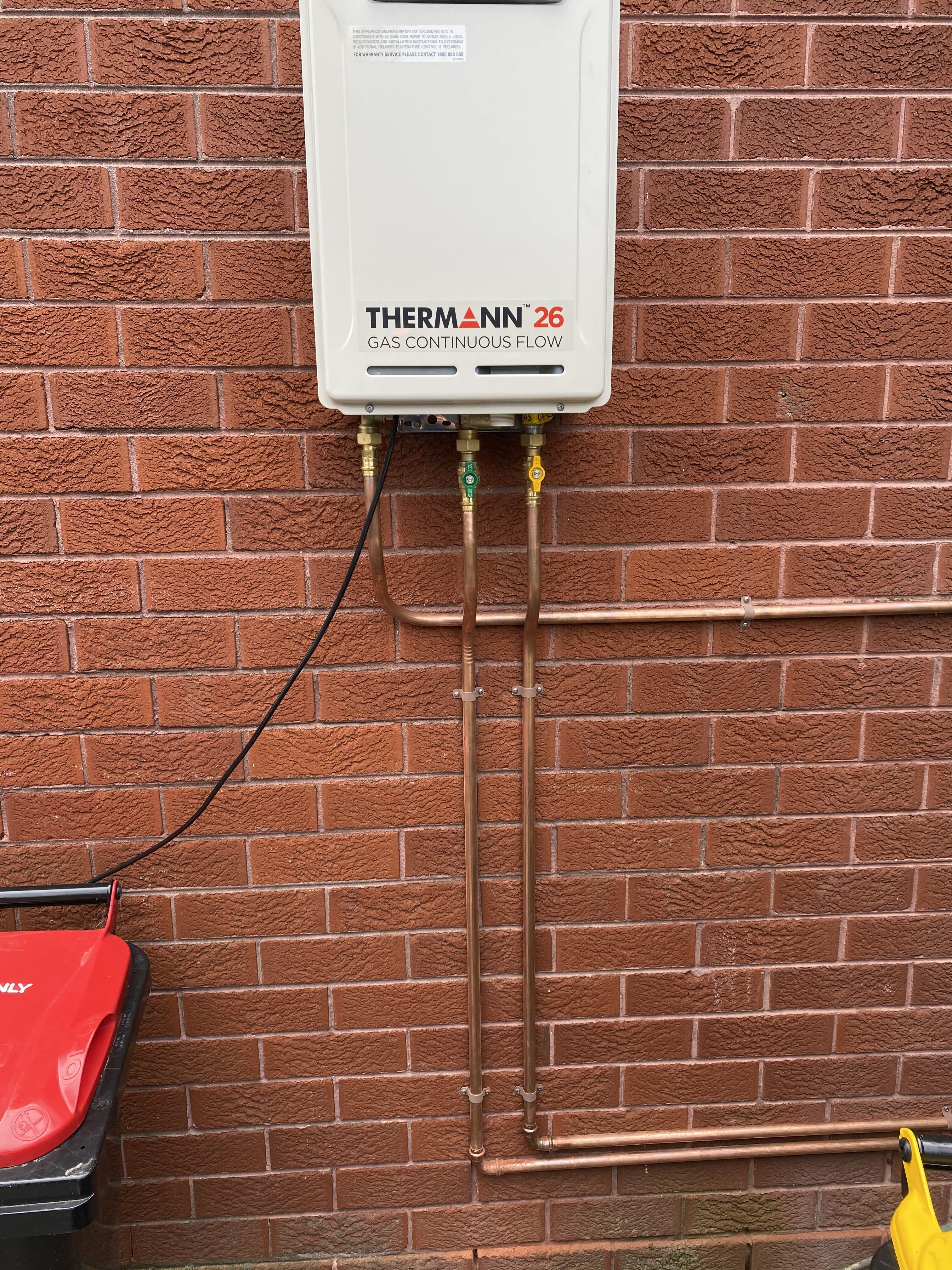 Thermann continuous flow unit on brick wall