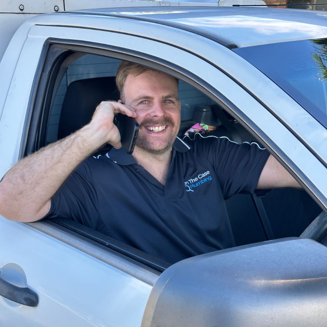 Casey from On The Case Plumbing smiling on the phone