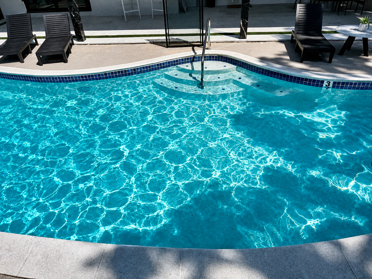 Pool cleaning service in Naples, FL backyard pool with crystal clear water