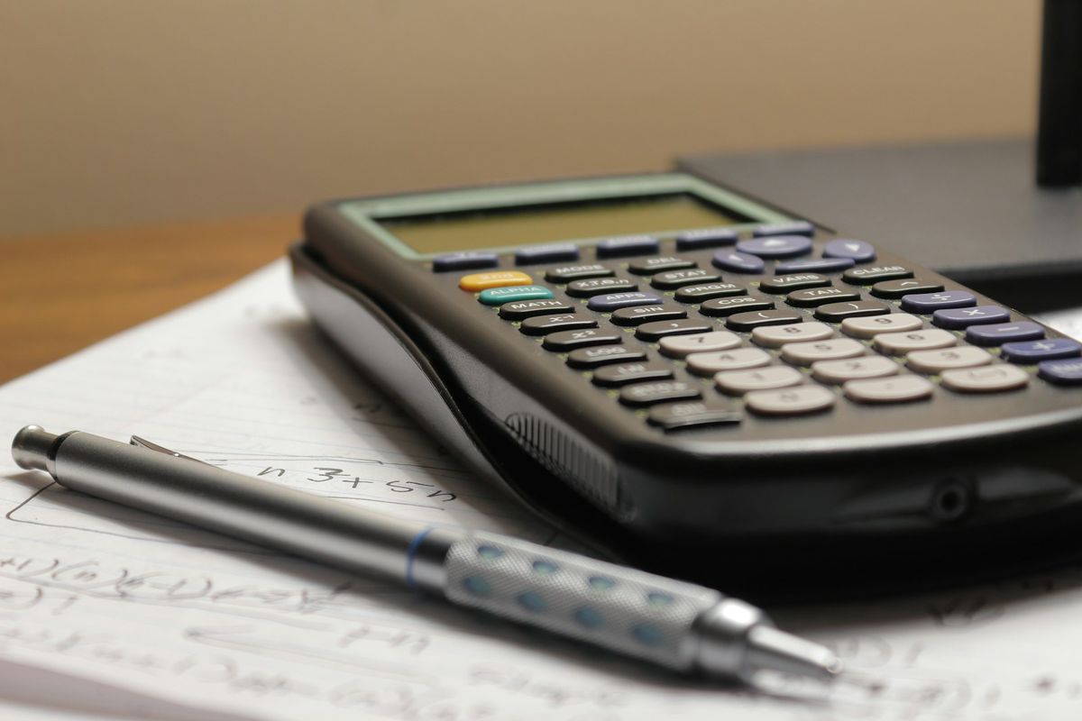 A calculator and pen on paperwork A calculator and pen on paperwork
