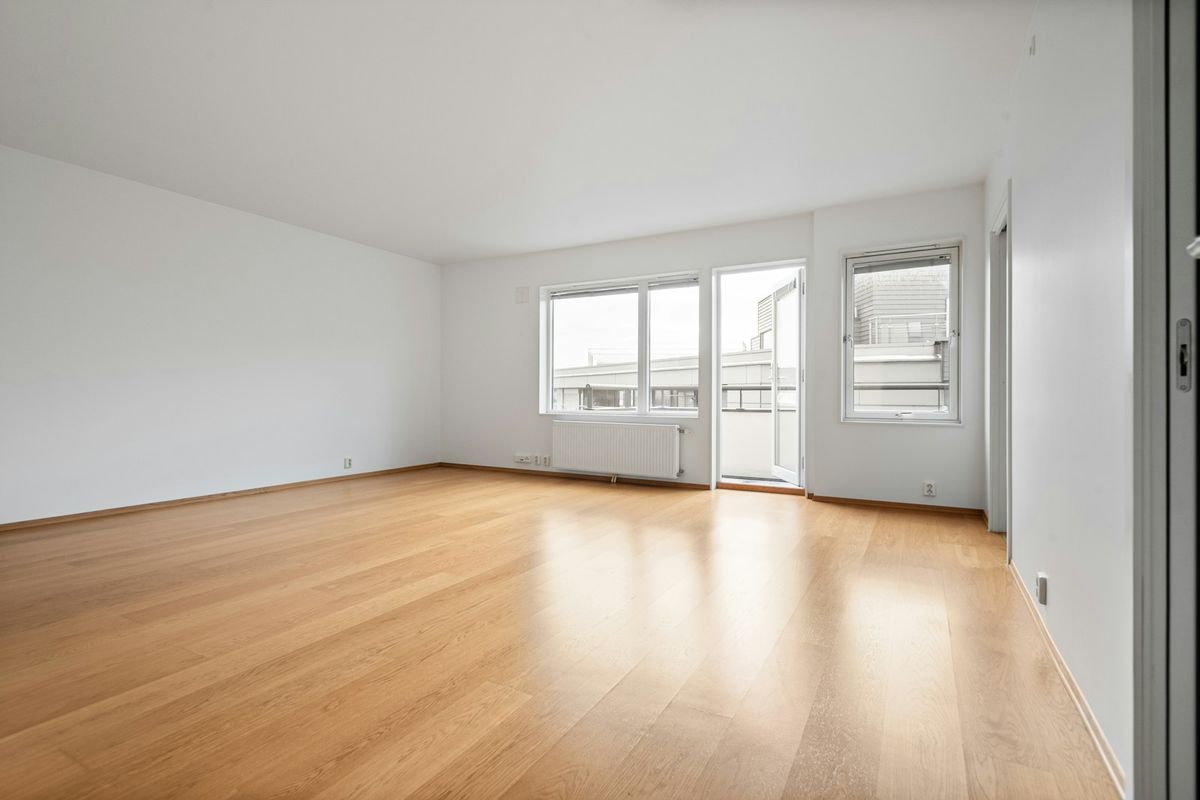 An empty room with wood floors An empty room with wood floors
