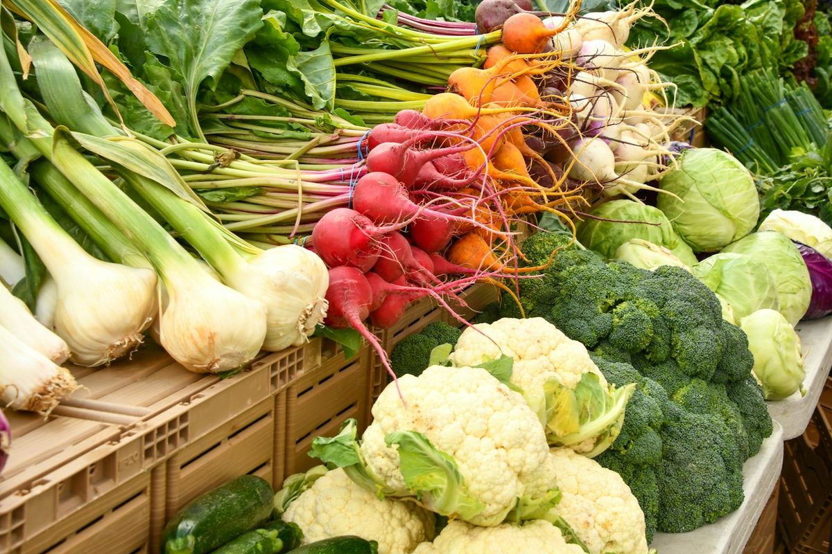 Fresh vegetables piled on a market table